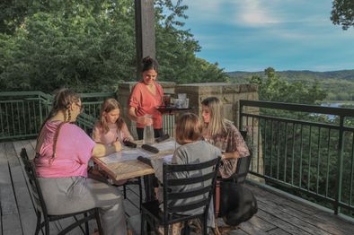 Family sits at a table on the patio of the restaurant.